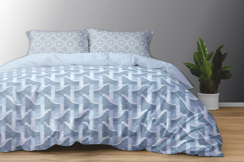 A king size bed sheet set with pillow covers displayed on a bed, featuring a geometric pattern in blue and white colors.